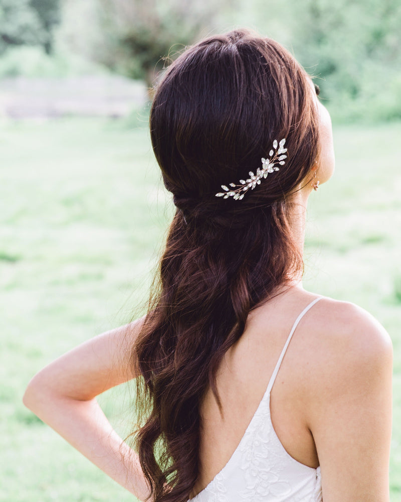 A bride wears the Aster Comb to the side of her half-up bridal hairstyle.