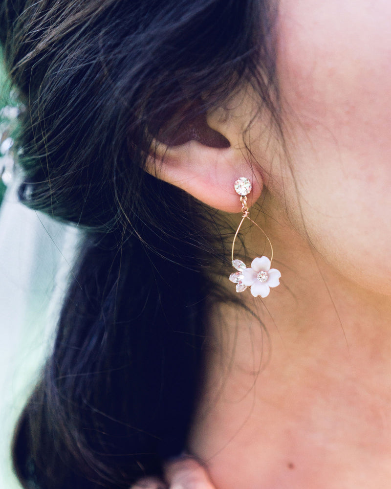 Close up on model of the Belle Fleur Earrings by Atelier Elise in rose gold with blush flowers and crystals.