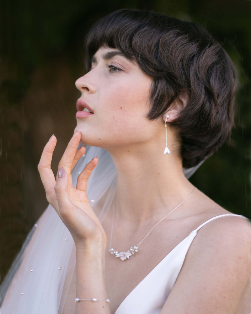 A bride models the Belle Fleur Drop Jewellery Set in silver.