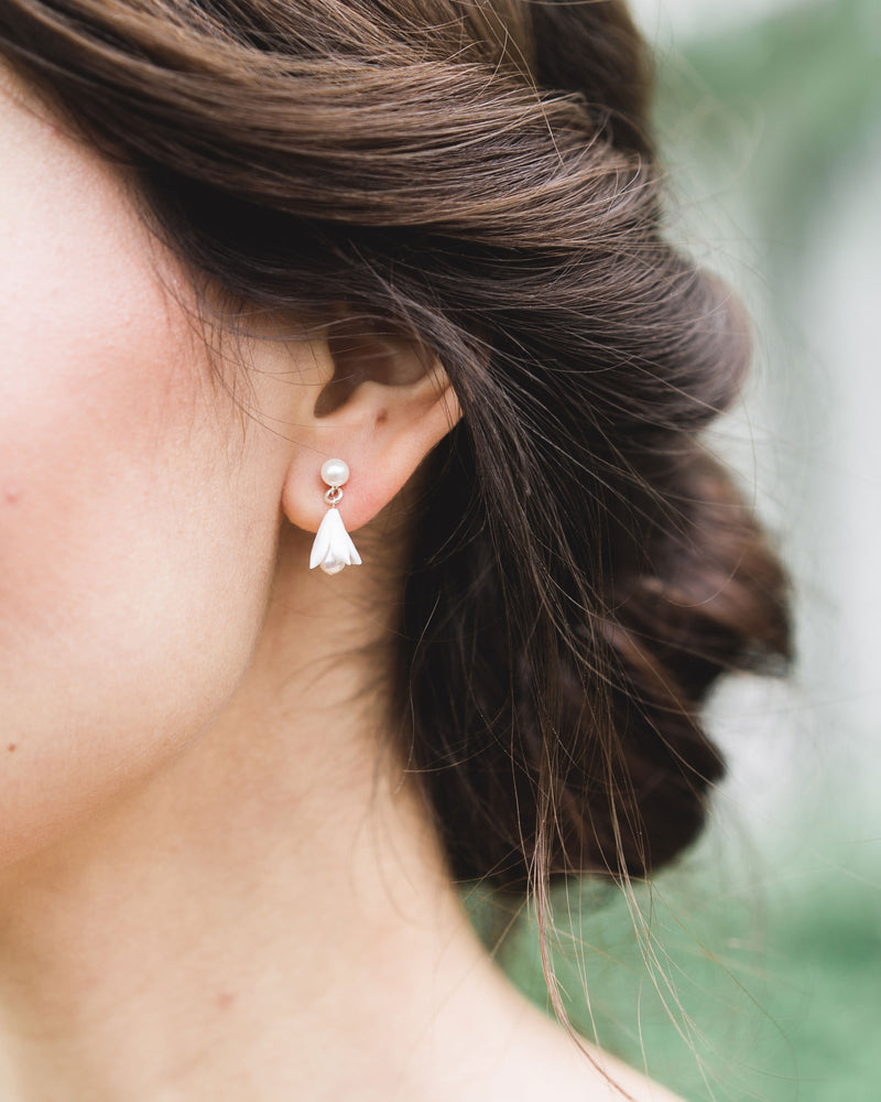 Close up of bride with low bun updo and drop Earrings; Belle fleur small drop bridal earrings with pearls and clay flowers.