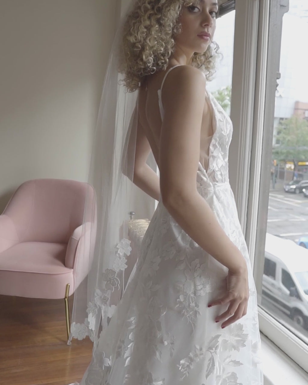 A model wears the Wildflower Floral Lace Veil with a Made With Love bridal gown.