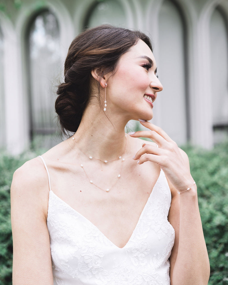 Model wearing the dainty pearl layered necklace in rose gold, paired with the matching dainty pearl trio earrings.