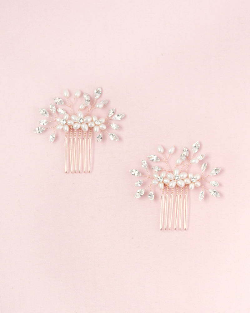 Flatlay of a pair of Delicate Bridal Combs in rose gold, with pearls and crystals.