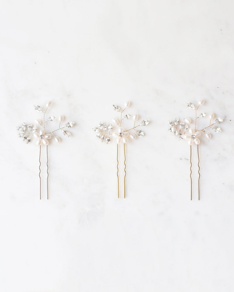 Flatlay view of the Everthine Hair Pins in pearl and crystal. Shown in silver, gold, and rose gold.