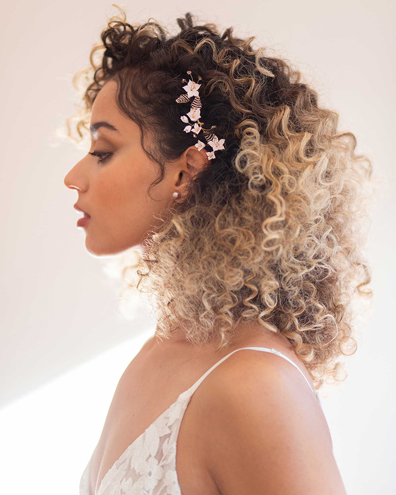 A model wears the Lily Floral Hair Pins set of 3 with our Classic Pearl Stud Earrings in blush.