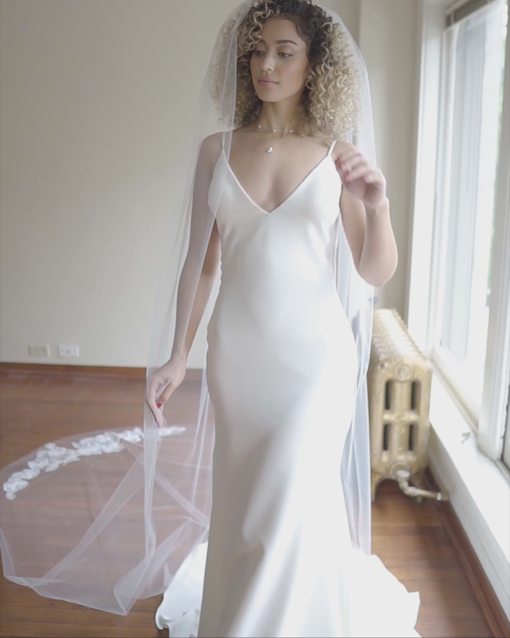 A video featuring the Camellia Long Lace Veil in cathedral length.