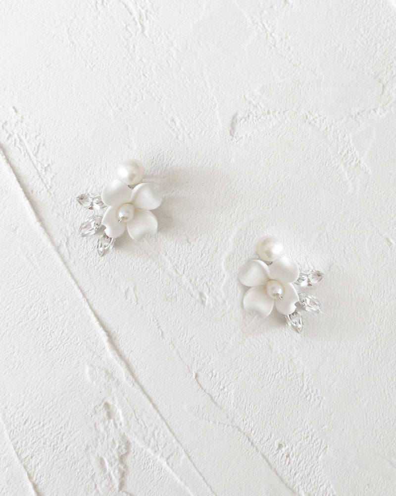 Close flatlay view of the Belle Fleur Cluster Earrings in silver with ivory flowers.