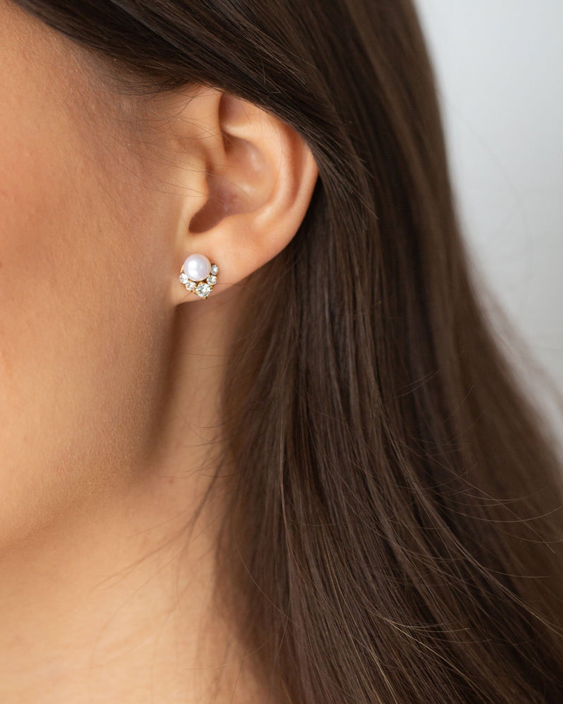 A close model view of the Petite Celestial Pearl Cluster Earrings in gold with freshwater pearls and crystals.