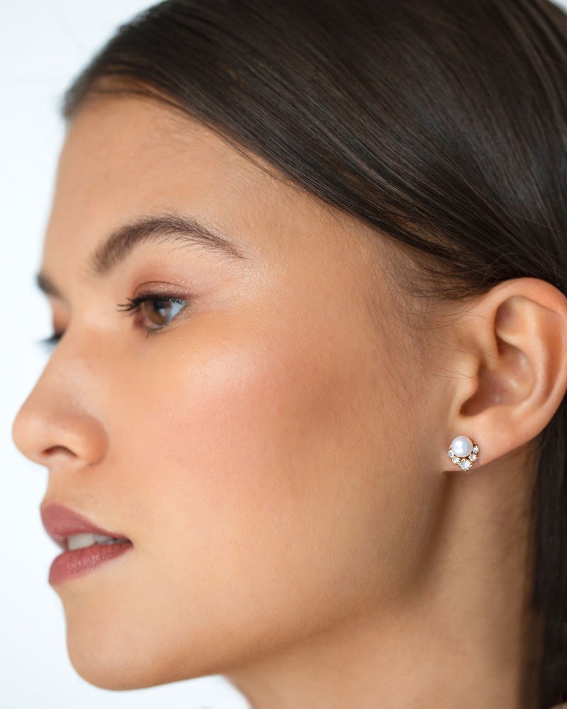 A close model view of the Petite Celestial Pearl Cluster Earrings in gold with freshwater pearls and crystals.