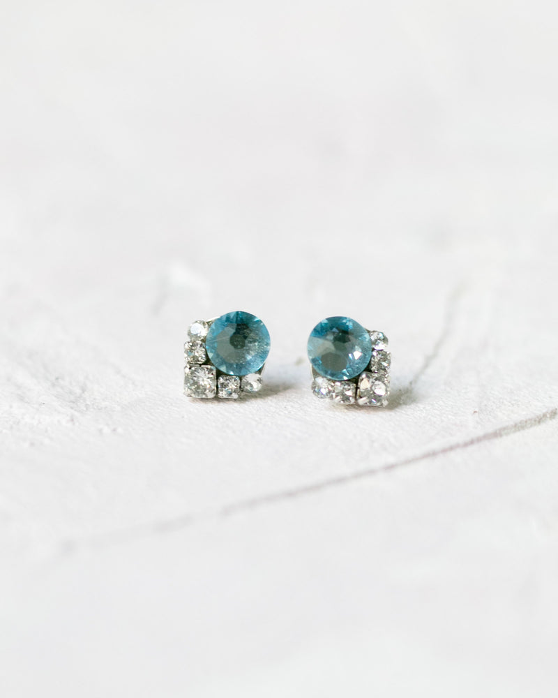 Close-up of the Celestial Crystal Cluster Earrings in silver with an aquamarine centre crystal.
