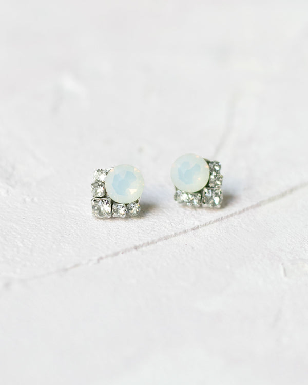 Close-up product view of the Celestial Crystal Cluster Earrings in silver with white opal crystals.