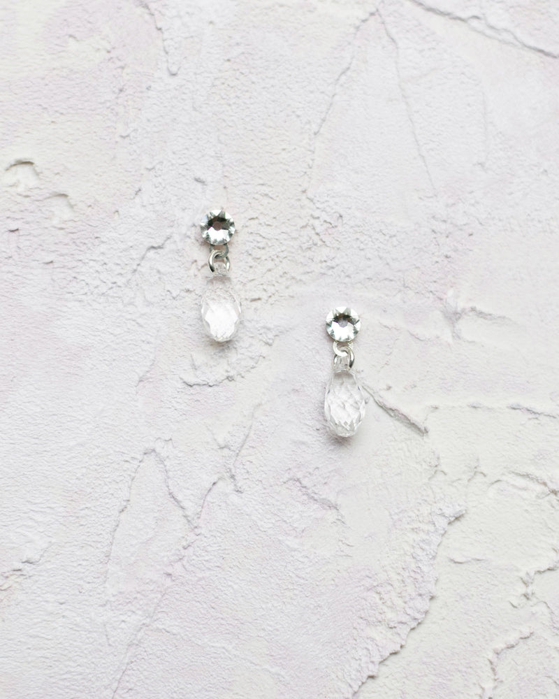 Flatlay of our Dewdrop Earrings in silver. Delicate drop bridal earrings for brides and bridesmaids.