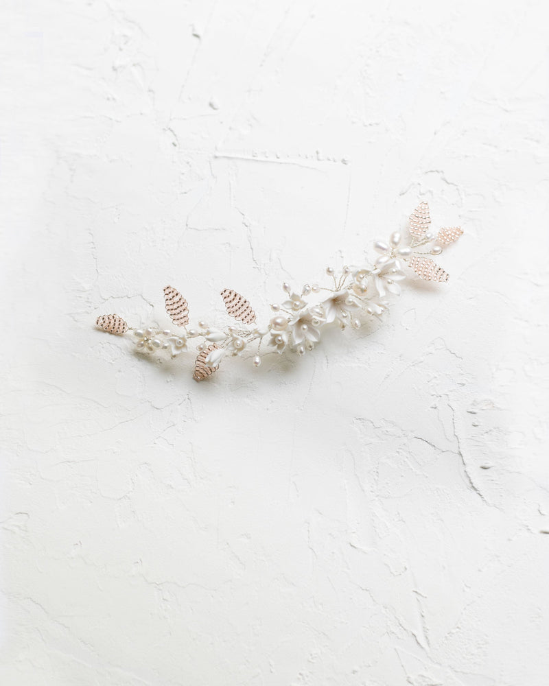 Flatlay view of the Lily Floral Comb in silver with blush beading and ivory flowers.