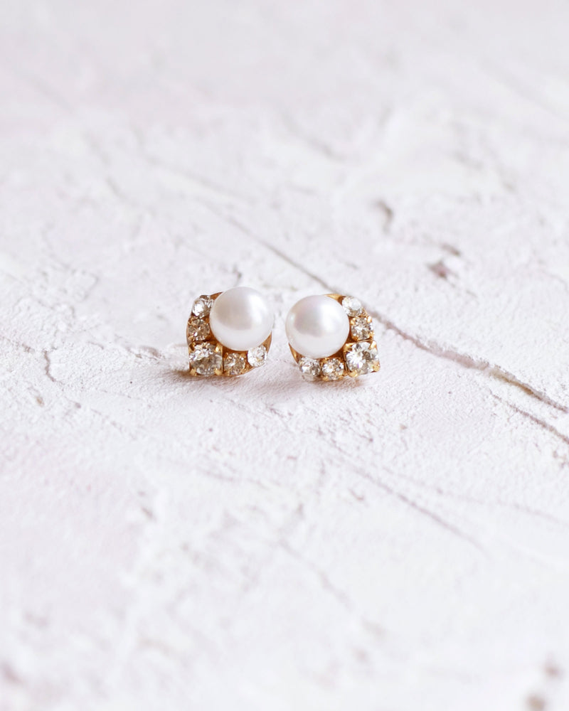 Flatlay view of the Petite Celestial Pearl Cluster Earrings in gold with freshwater pearls.