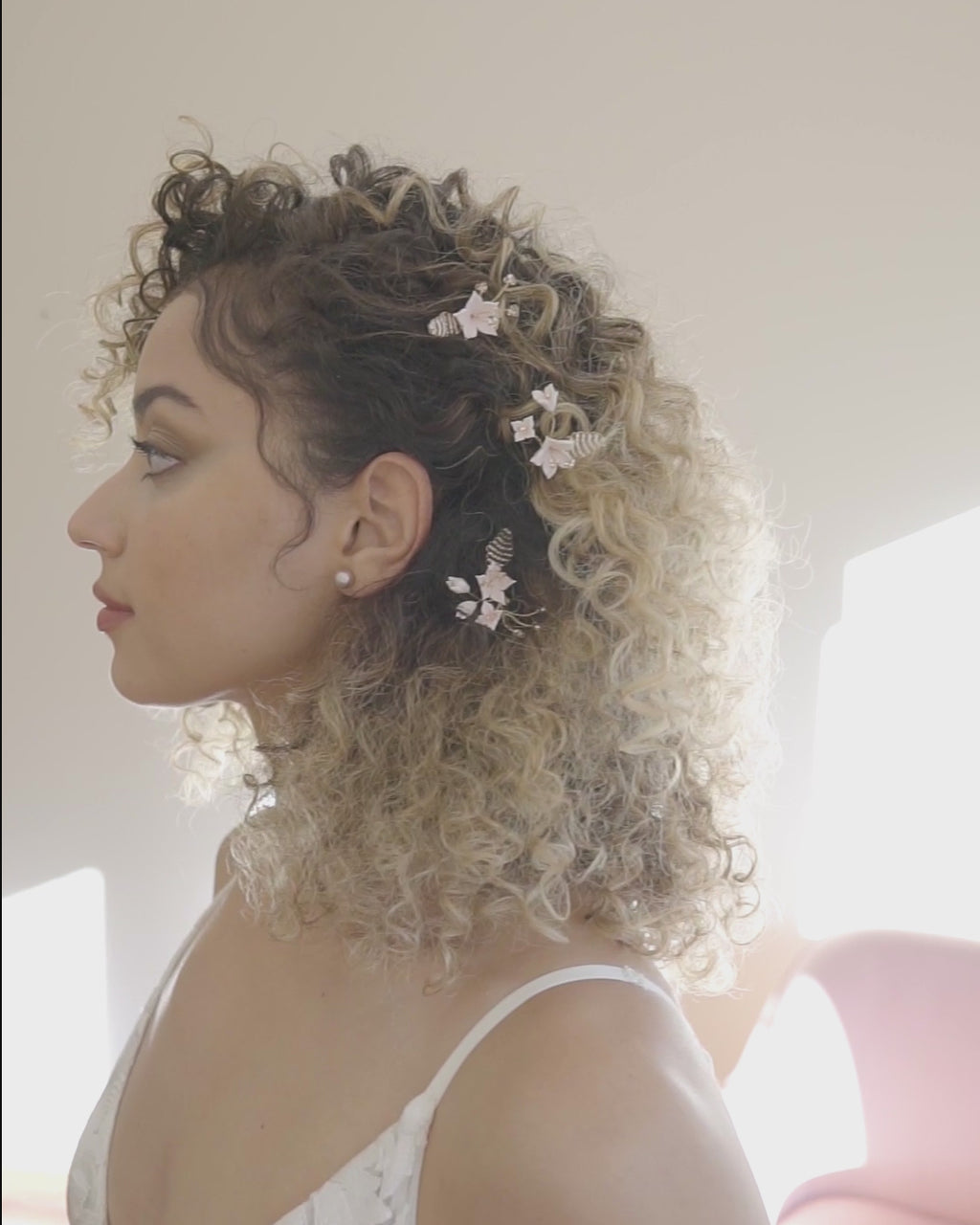 A model wears the Lily Floral Hair Pins in gold with our Classic Pearl Stud Earrings in blush.