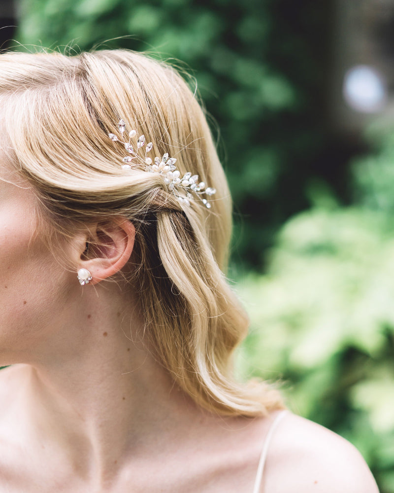 A close model view of the Aster Bridal Hair Comb with pearls and crystals.