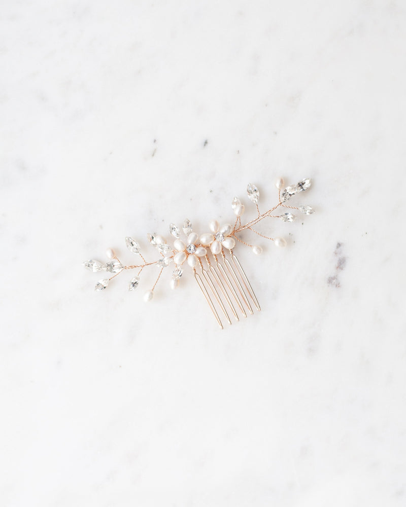 Flatlay of the Aster bridal hair Comb in rose gold with pearls and crystals.