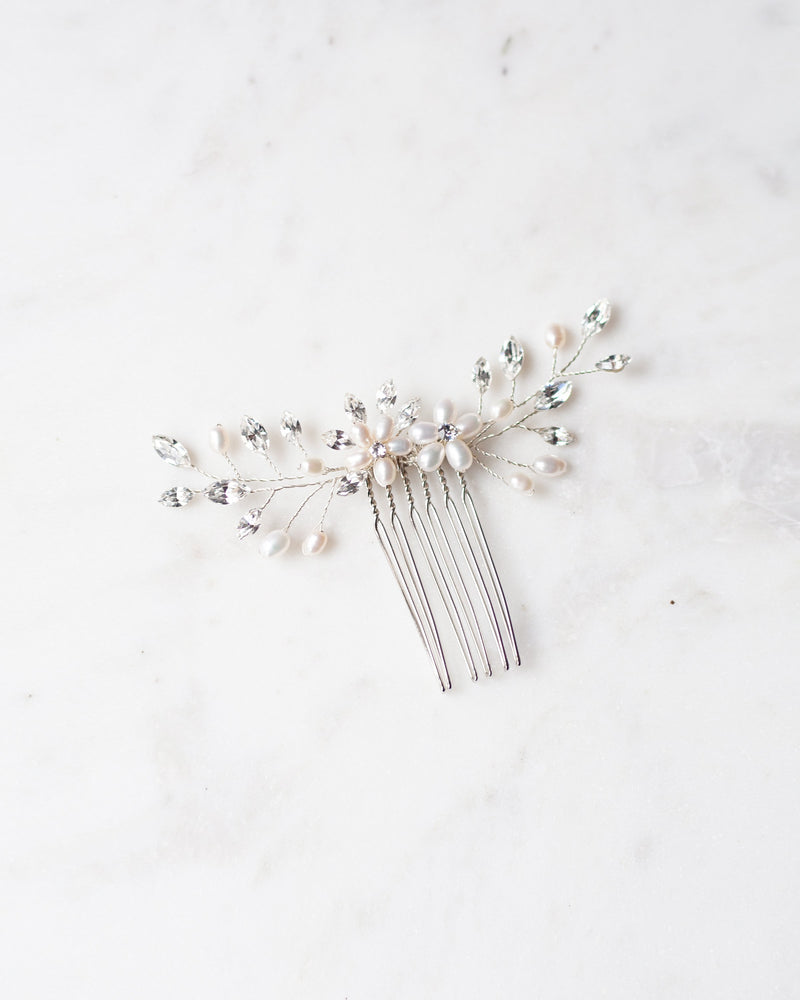 Flatlay of the Aster bridal hair Comb in silver with pearls and crystals.