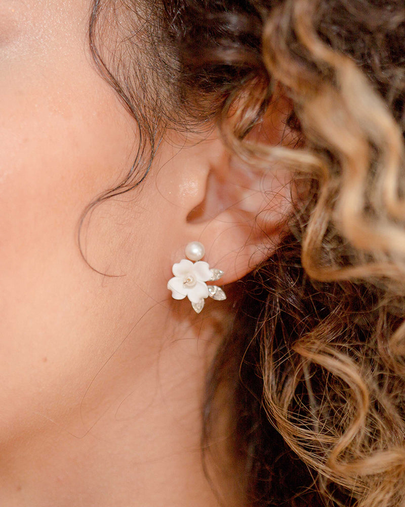 Close on ear view of the Belle Fleur Cluster Earrings in silver with ivory flowers.
