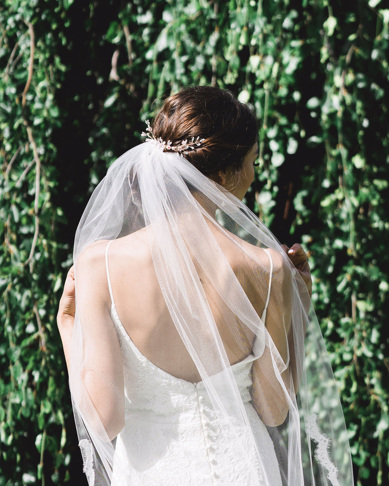 Back view of bride wearing the Belle Fleur Grand Comb styled above a simple veil.