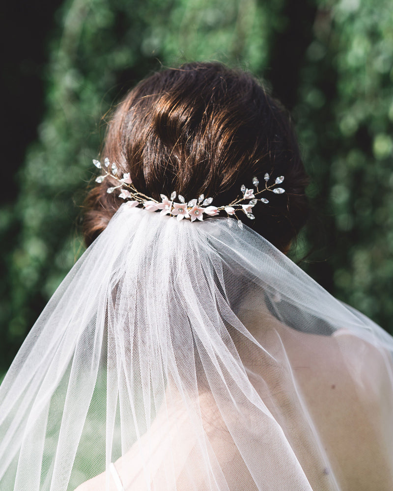 Belle Fleur Grand Bridal hair Comb by Atelier Elise styled with a low updo above a tulle veil.
