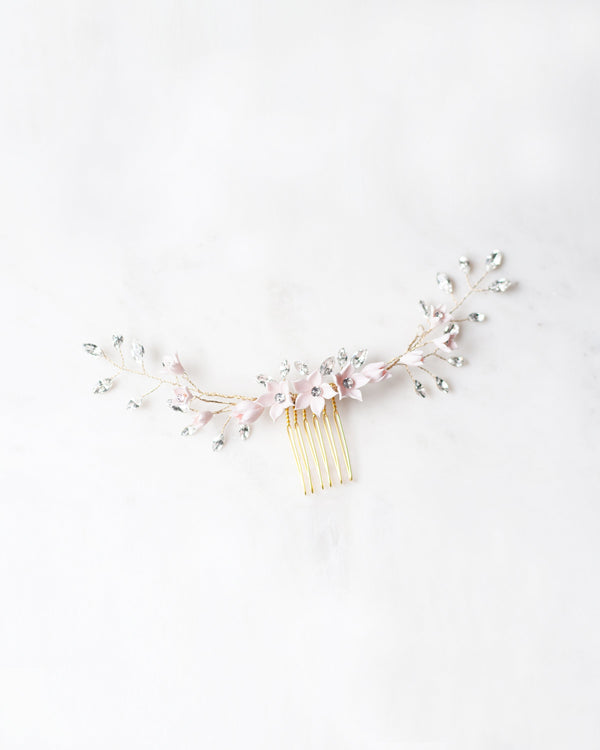 Flatlay of the Belle Fleur Grand Comb in gold with blush flowers and crystals.