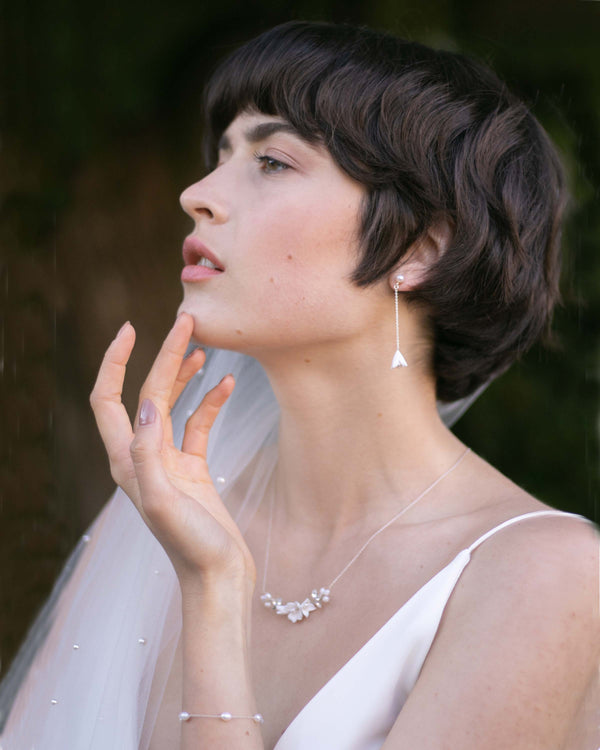 A bride models the Belle Fleur Drop Jewellery Set in silver.