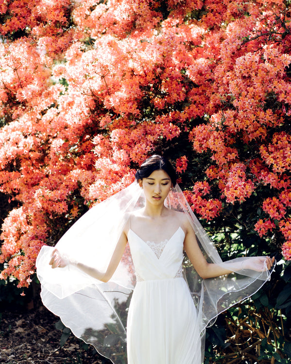 Model wearing Calla ribbon-edged bridal veil