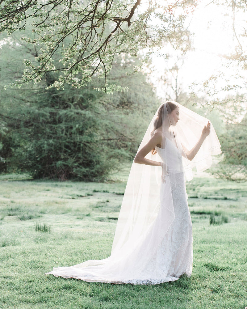 Model wearing calla bridal veil with blusher ribbon edge