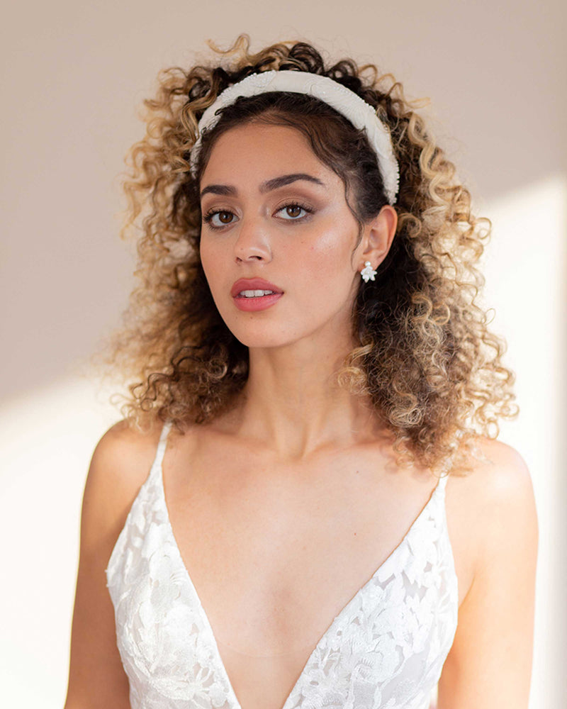 A model wears the Camellia Padded Bridal Headband with the Belle Fleur Cluster Earrings.