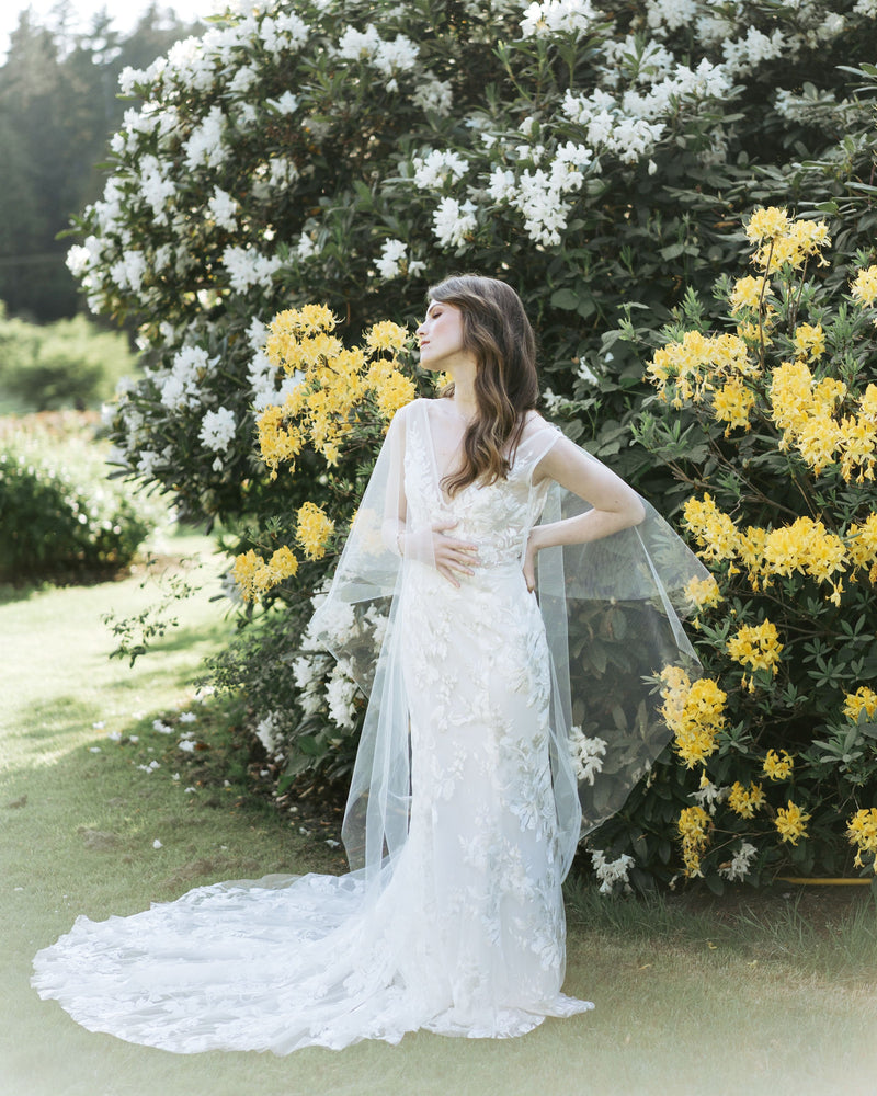 model wearing cascading leaves tulle bridal cape veil