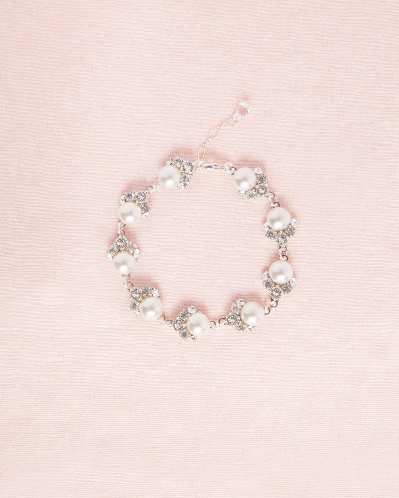 Flatlay of the Celestial Pearl Cluster Bridal Bracelet in silver with white pearls.