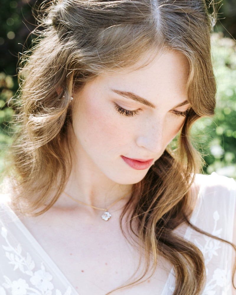 A bride with auburn hair models the Celestial Crystal Drop Necklace in gold/crystal.