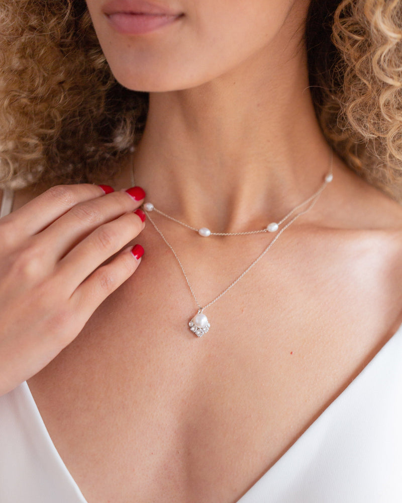 A close on model view of the Celestial Pearl Necklace in silver with natural freshwater pearls.