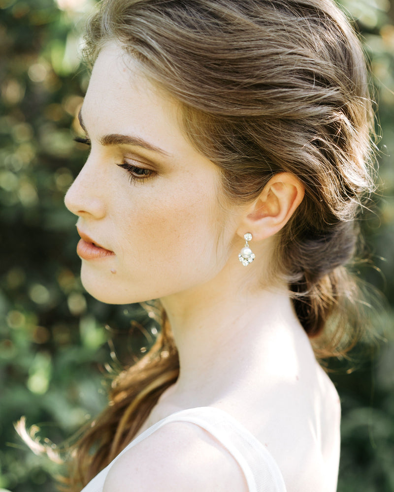 An auburn-haired model wears the Celestial Pearl Drop Earrings in silver with white pearls.
