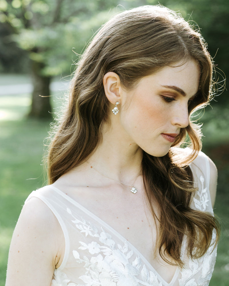 A bride with auburn hair wears the Celestial Pearl Drop Jewellery Set. The delicate pearl drop necklace matches her pearl drop earrings.