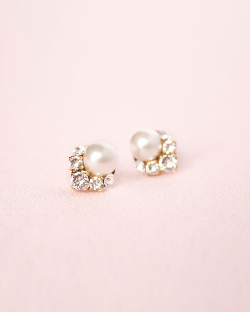 A close-up product view of the Celestial Pearl Cluster Earrings in gold with cream pearls.