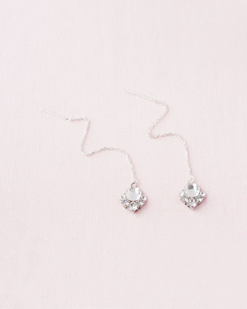 Flatlay of the Celestial Crystal Threader Earrings in silver/crystal.