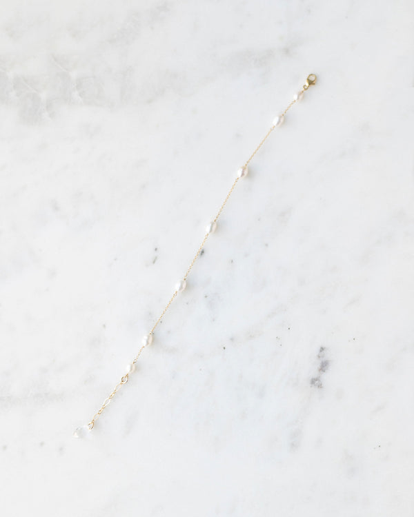 A flatlay of the dainty freshwater pearl bracelet in gold.