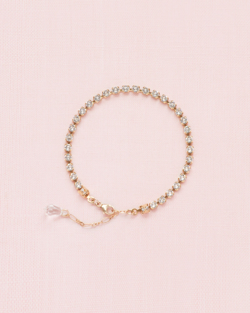 Flatlay of the Delicate Crystal Tennis Bracelet in gold.