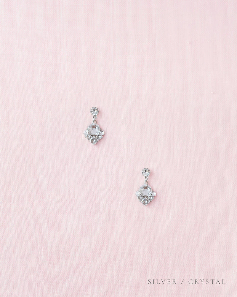Flatlay of the Celestial Crystal Drop Bridal Earrings in silver with all crystal.