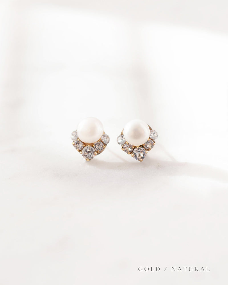 A close-up product view of the Celestial Pearl Cluster Earrings in gold with natural freshwater pearls.