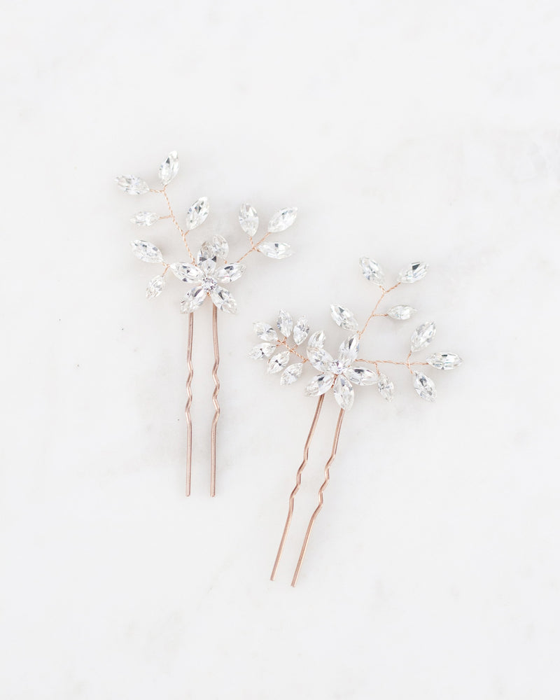 Flatlay view of the Everthine Hair Pins in rose gold with all crystal.