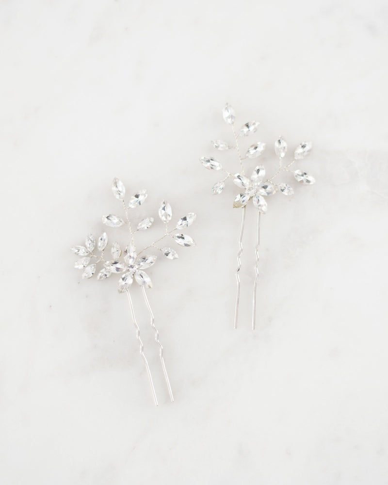 Flatlay view of the Everthine Hair Pins in silver with all crystal.