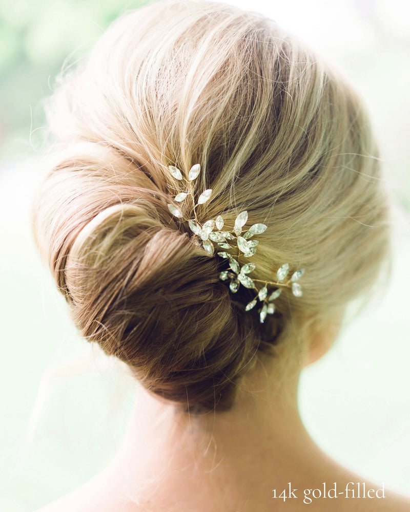 Close model view of the Everthine Crystal Hair Pins styled into a modern bridal French twist. The pins are gold with crystals.