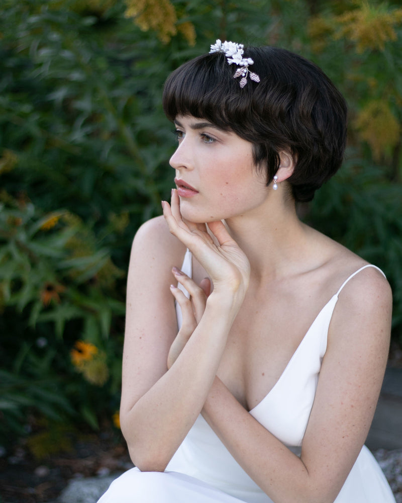 A side view of bride wearing the Lily Floral Crown in silver with ivory flowers and blush beads.