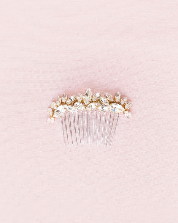 Flatlay of glam bridal comb in gold with dazzling crystals.