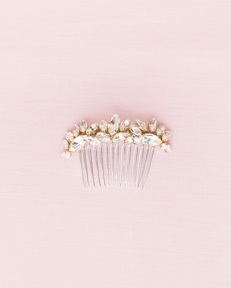 Flatlay of glam bridal comb in gold with dazzling crystals.