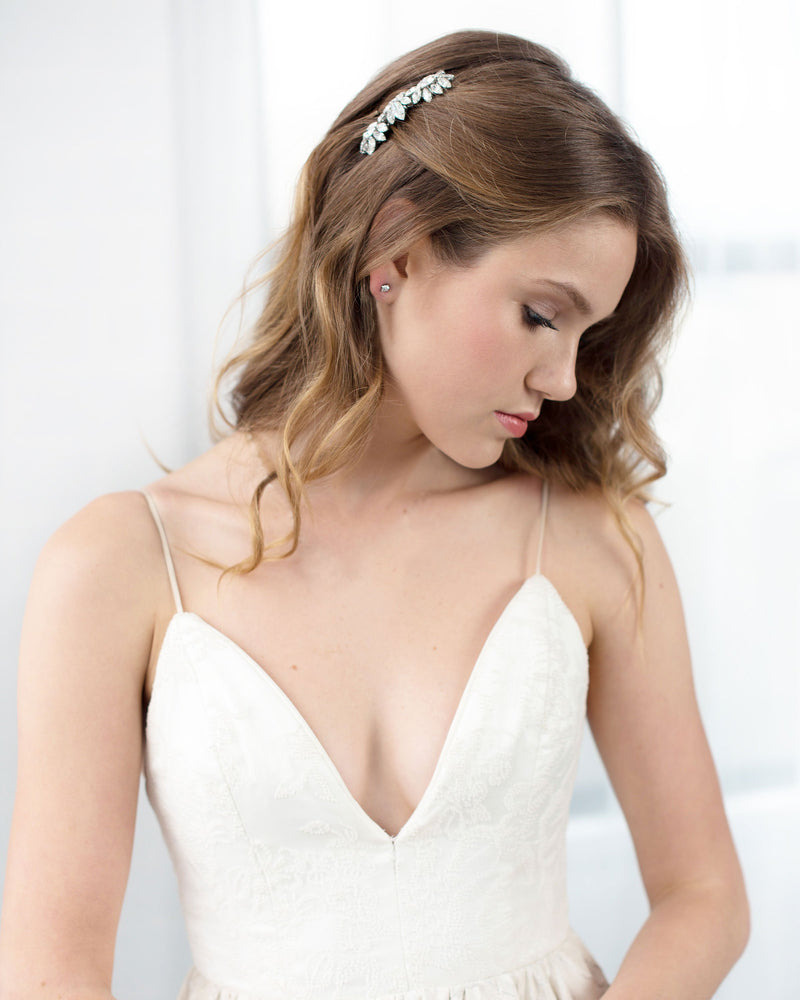 A model wears her hair in soft bridal waves, with the Lotus Flower Crystal Comb placed above her ear.