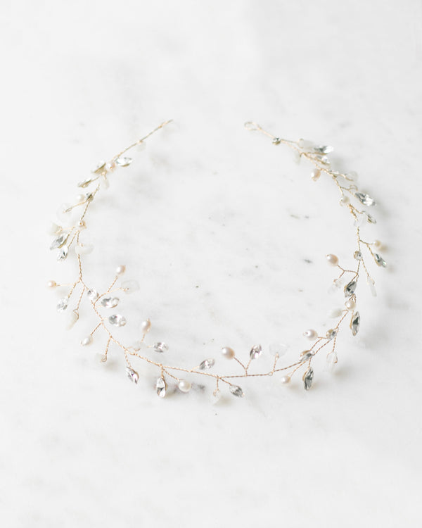 Flatlay of the Moonflower Bridal Hair Vine in gold, with moonstone, pearls, and crystals.